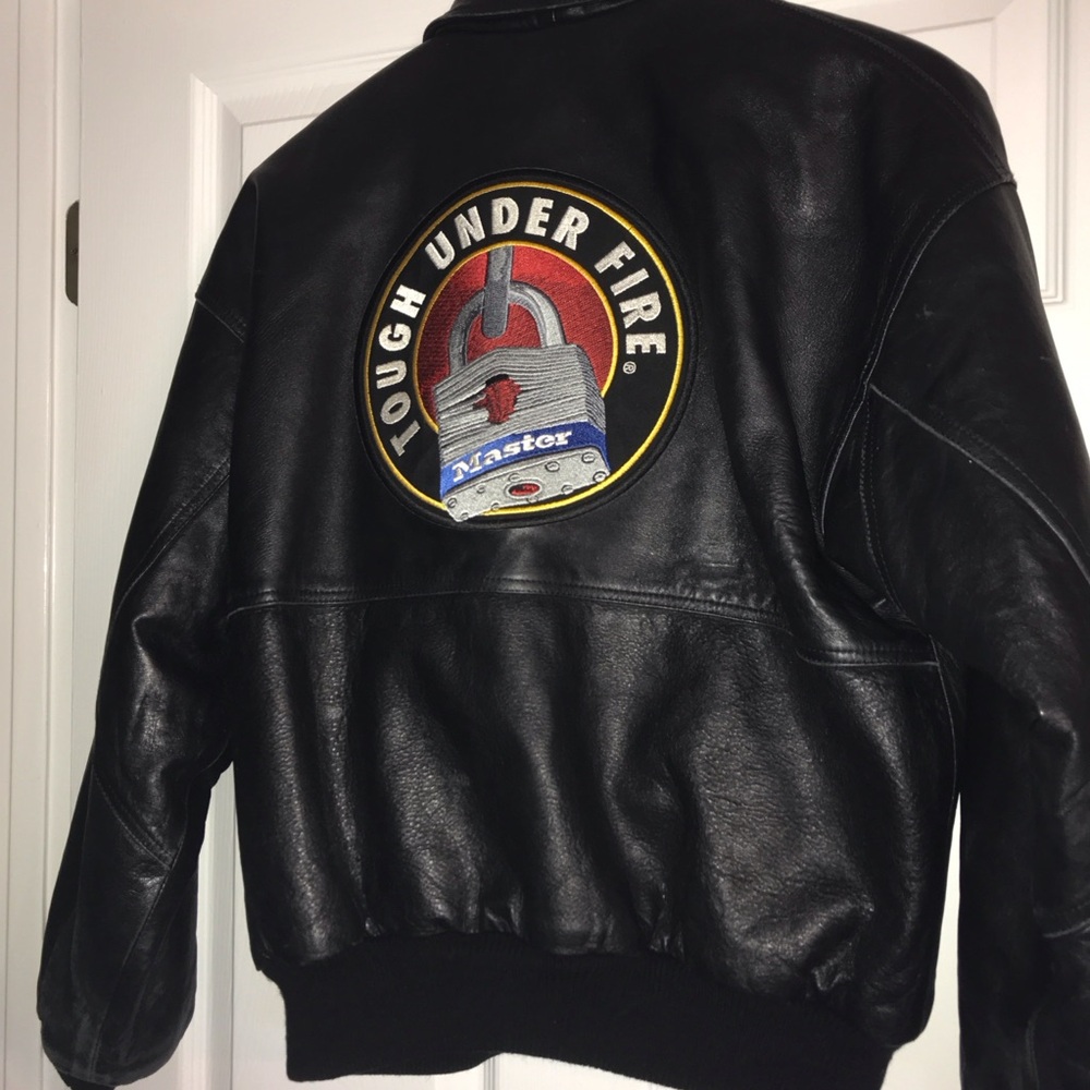 Genuine leather jacket. Vintage Master Lock Co. “Tough Under Fire” logo on back.